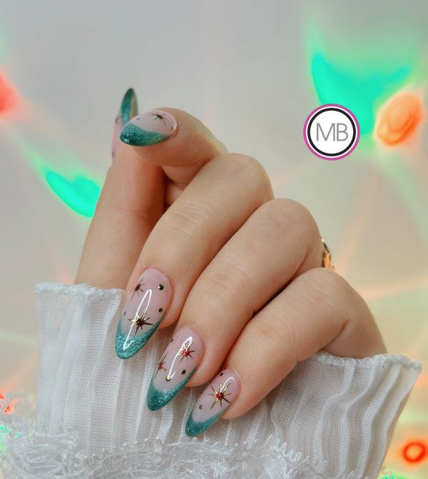 Close-up teal glitter French tip almond nails with starburst nail art by ManiBliss nail salon Duluth GA