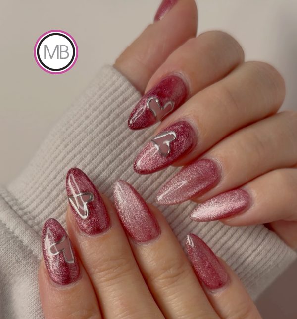 Deep burgundy cat-eye shimmer almond nails with silver chrome heart outlines by ManiBliss nail salon Alpharetta GA